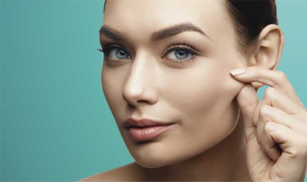 Sofwave ultrasound skin lifting London - woman pinching the skin on her cheek Woman pinching the skin on her cheek for Sofwave ultrasound skin lifting in London